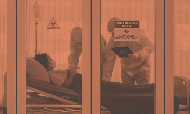 two doctors in protective suits visit quarantined patient