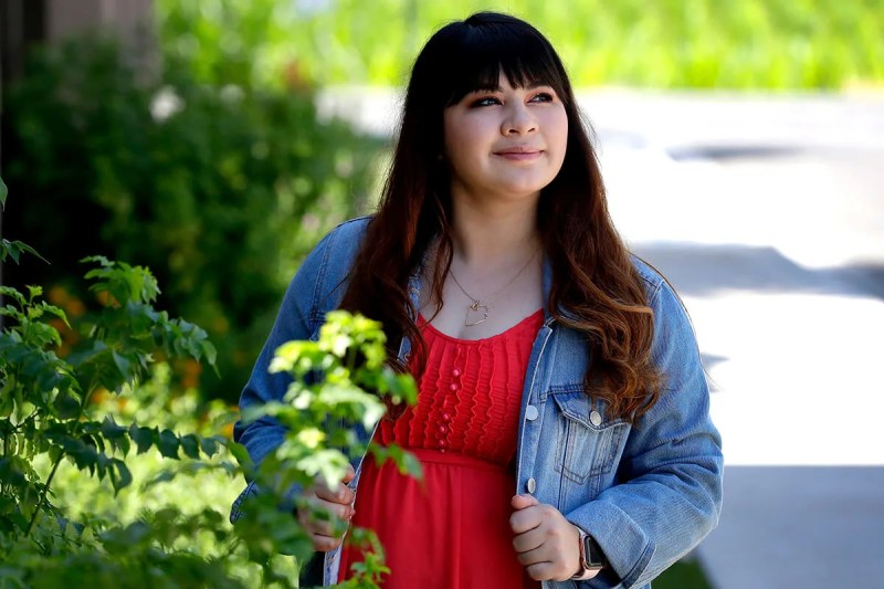 Reyna Montoya stands outside her home