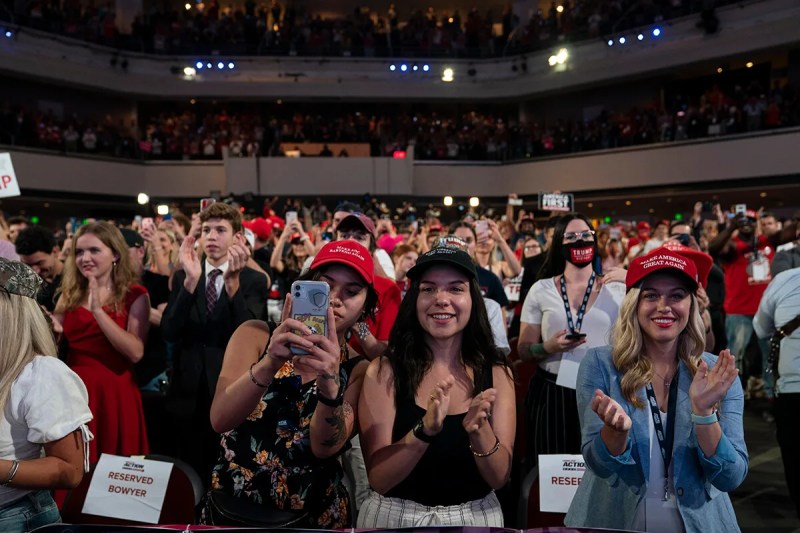 crowd cheering for President Trump inside church auditorium