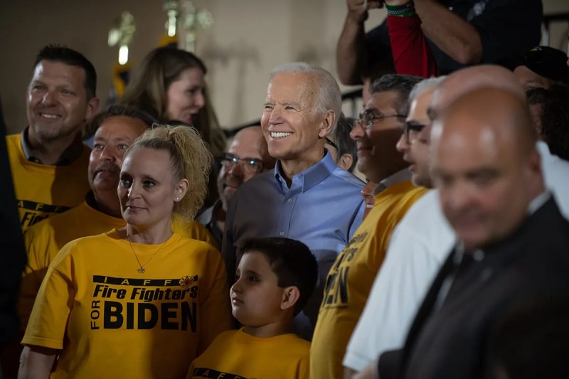 Joe Biden posing for photo with supporters at a rally