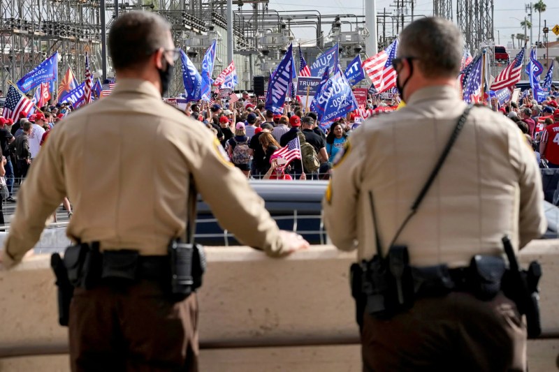 Maricopa County Sheriff's Deputies watch the crowd during a pro Trump rally from the steps of the Maricopa County Recorder's Office.