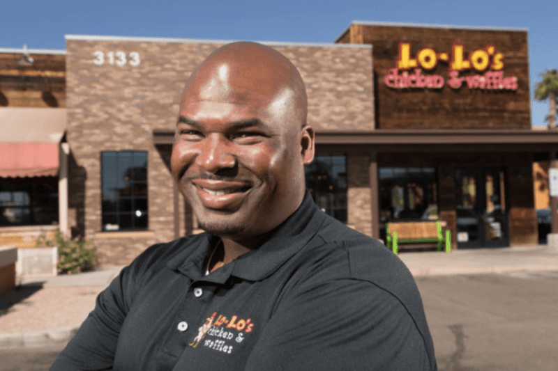 Larry White in front of a Lo-Lo's restaurant
