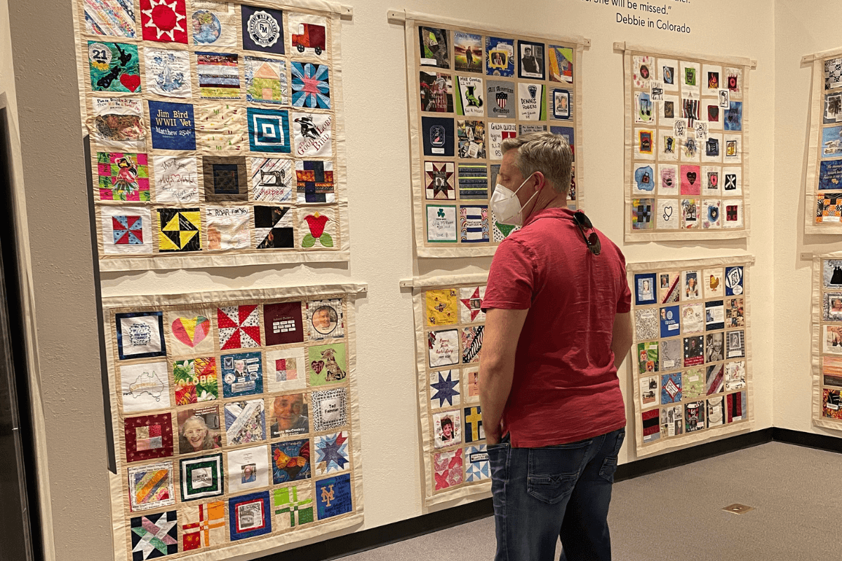 a man viewing the COVID Memorial Quilt