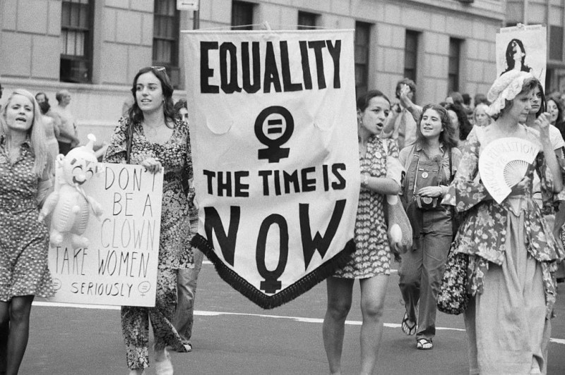women marching with protest signs