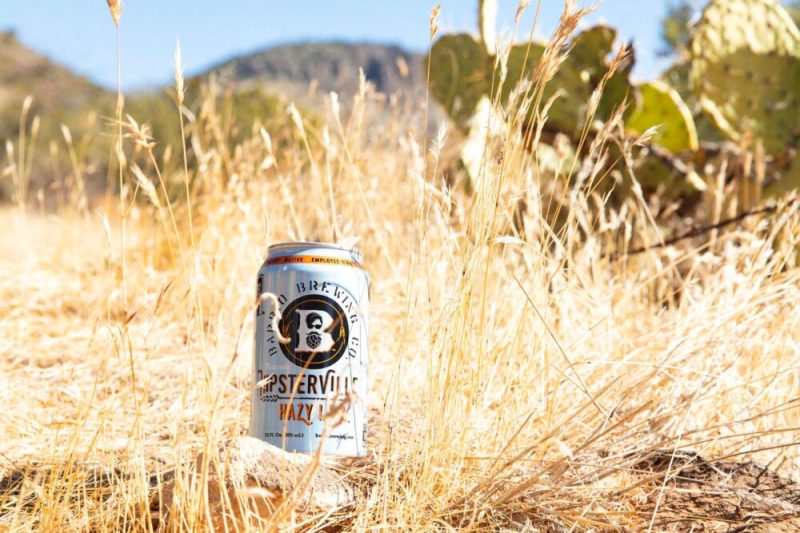 A Barrio beer can sitting in the Arizona desert.