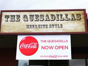 Outdoor sign that says The Quesadillas.