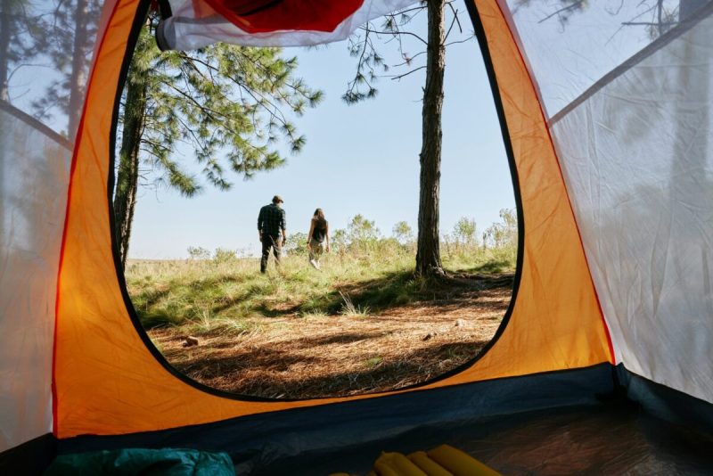 Shot of a couple walking away from their tent.