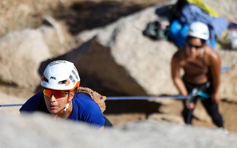 two women rock climbing
