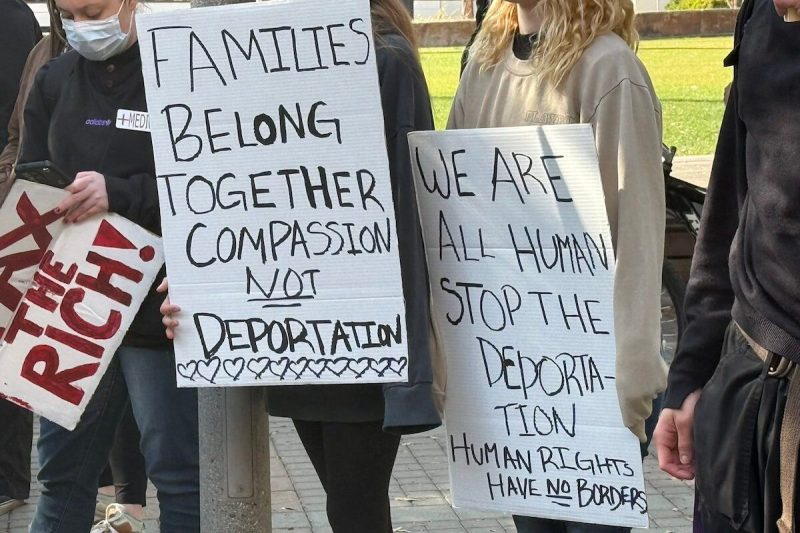 people holding signs supporting immigrants