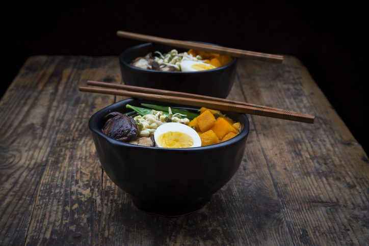 Ramen with noodles, egg, hokkaido pumpkin, mung sprout, shitake mushroom in bowl, chopsticks