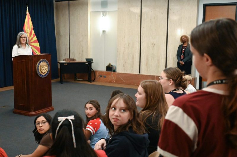 Hobbs facing a group of children