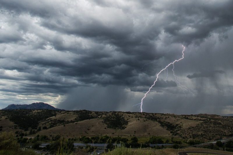 lightning flashes across the sky