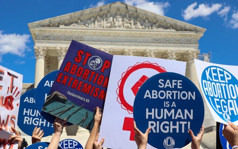 people holding signs supporting abortion rights