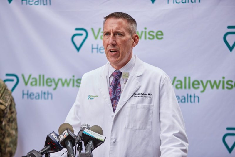 Dr. Michael White, chief clinical officer of Valleywise Health, speaks to the news media