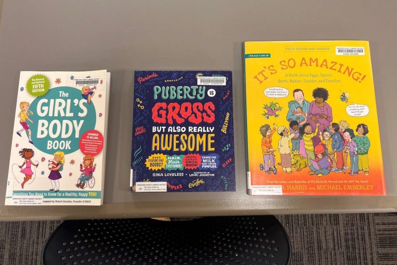 three children's books related to puberty laid on a table