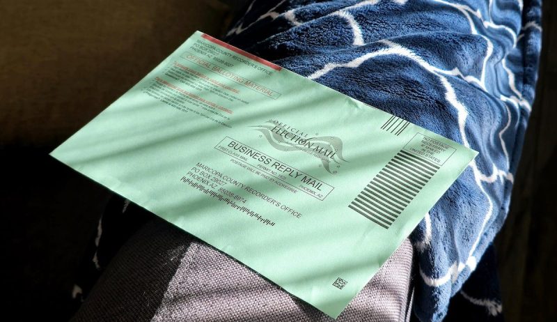 a green mail-in ballot envelope
