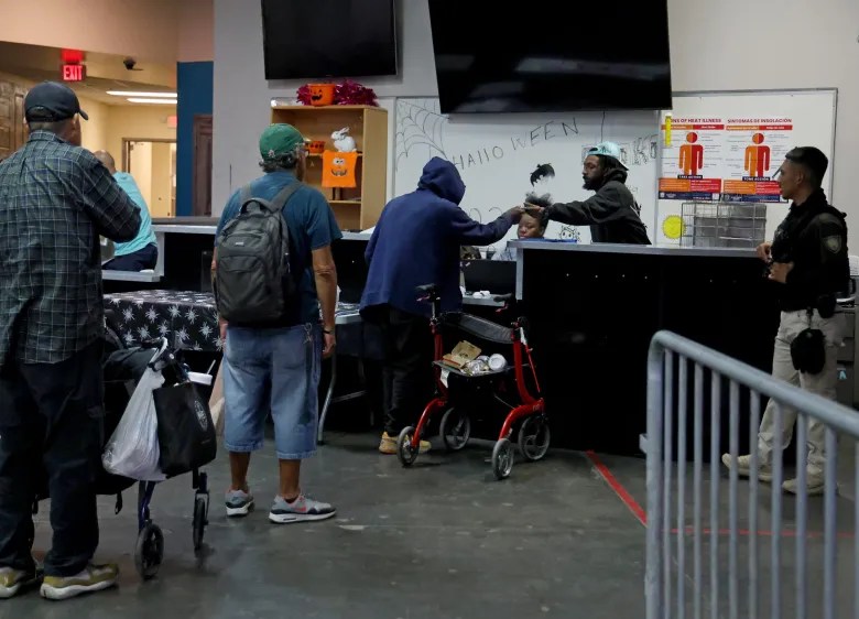 Clients of Keys to Change wait in line in the Lodestar Day Resource Center