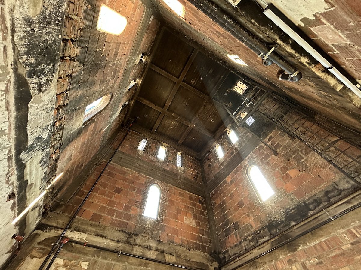view looking up inside of a brick bell tower