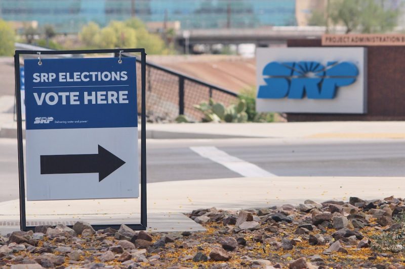 a sign outside of an SRP building pointing voters toward polling booths