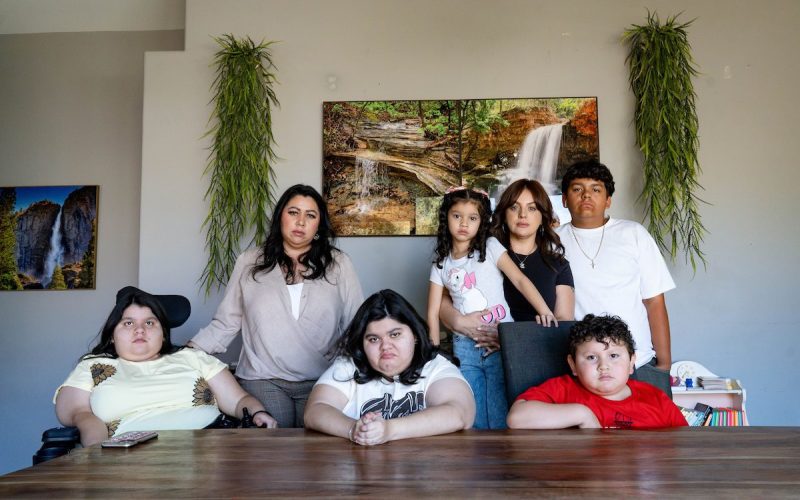 a family of women and children posing at a table